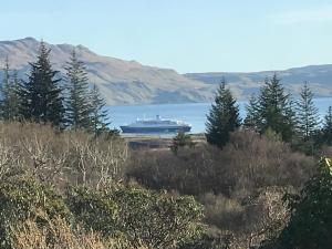 a large boat in a large body of water at Linndhu House in Tobermory