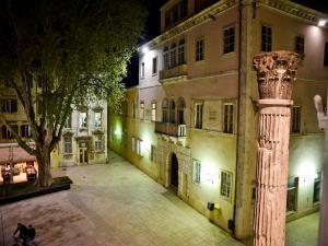a column in front of a building at night at Luxury room Colonna 4*, center in Zadar