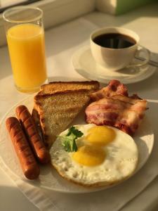 a plate of breakfast food with eggs sausage and toast at Concept Hotel in Khimki