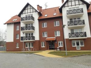 a building with balconies on the side of it at Apartament Nadmorski Zalewowa 12G in Sztutowo