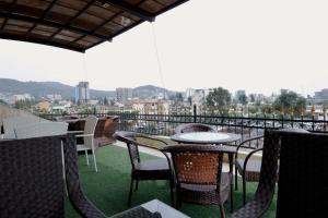 a patio with tables and chairs on a roof at Afropolitan Hotel in Addis Ababa