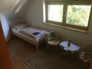 a bedroom with a bed and a table and a window at Studio Pohoda Na Razcesti Cingov Slovensky Raj in Spišské Tomášovce