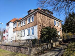 a large house with a fence in front of it at Ferienwohnung Hochgefühl in Hohegeiß