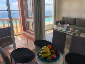 a plate of fruit on a table in a living room at Apart. Playa La Barca in Costa Calma