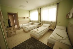 a large room with two beds and a tv at Standard Delegacyjny Bed & Breakfast in Dąbrowa Górnicza