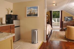 a living room with a kitchen and a room with a bed at Victorian Luxury One Bedroom Apartment in St. Augustine