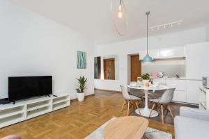 a living room with a dining room table and a kitchen at ShortStayPoland Krucza (B34) in Warsaw