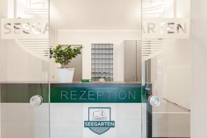 a sign that reads reception in a building at Seegarten Appartements Büsum in Büsum