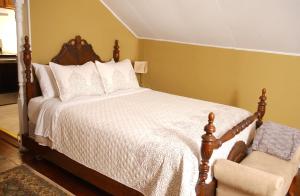 a bedroom with a bed and a chair at Victorian Luxury One Bedroom Apartment in St. Augustine