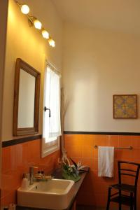 a bathroom with a sink and a mirror at Hotel Villa Pimpina in Carloforte
