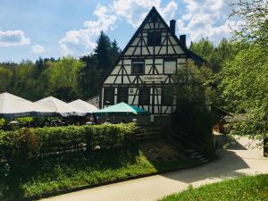 a black and white building with umbrellas in front of it at Schlößlesmühle in Leinfelden-Echterdingen