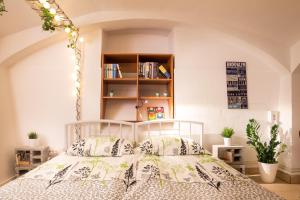 a bedroom with a bed and a book shelf at The Maze Apartment in Ljubljana