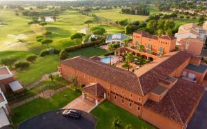 an aerial view of a large house with a yard at Palmyra Golf Hotel & Spa in Cap d'Agde