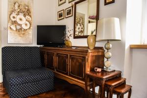 a living room with a tv and a chair and a table at Apartment Miguel in Kotor