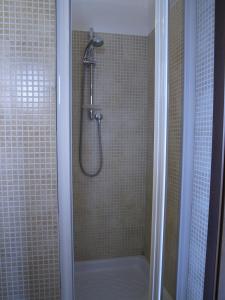 a shower in a bathroom with a glass door at Arco Michele in Putignano