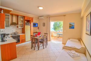 a kitchen and living room with a table and chairs at Beach House in Kissamos