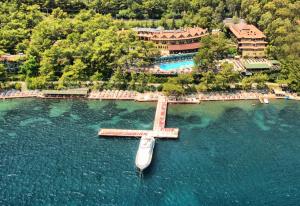 a boat in the water next to a resort at Marmaris Park Hotel in Marmaris
