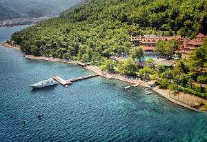 a boat is docked at a dock in the water at Marmaris Park Hotel in Marmaris