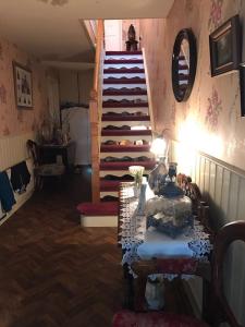 a living room with a staircase and a table with a lamp at Beau Vista in Strabane