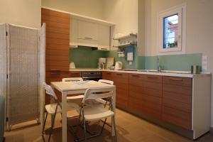 a kitchen with a table and chairs and a sink at Elies Houses in Agnontas