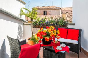 a balcony with a table with flowers on it at Venice Heaven Apartments - Ca Giulia apartment with private living TERRACE on last floor no lift in Venice