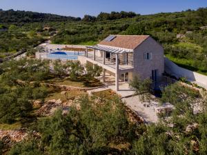 an aerial view of a house with a swimming pool at The Olive Tree Villa in Sumartin