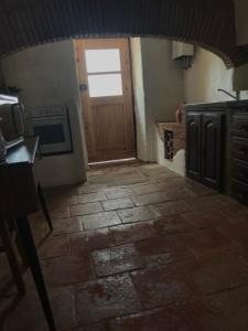a kitchen with a door and a stone floor at Herdade D. Pedro in Terena
