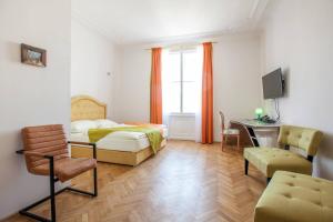 um quarto com uma cama, uma secretária e uma cadeira em Hotel Pension Museum em Viena