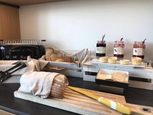 a kitchen with bread and other food items on display at MaisonMe Boutique Hotel in Bardolino