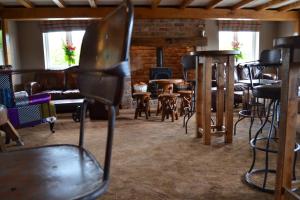 a living room with chairs and tables and a fireplace at The Barn Courtyard in Shepshed