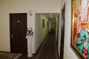 a hallway with a painting on the wall next to a door at Hotel "GRAND WAY" in Tashkent