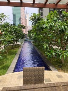 a pool in the middle of a city with trees at Onthree20 Residencies 2 Room 3 Bed Apartment in Colombo