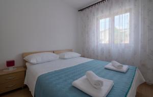 Postel nebo postele na pokoji v ubytování Apartman Ruža
