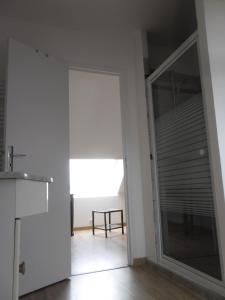 a kitchen with a sliding glass door leading into a room at Ferme de la roque in Millières