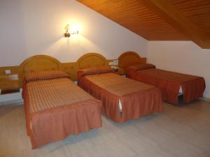 A bed or beds in a room at Hotel Silos 2000