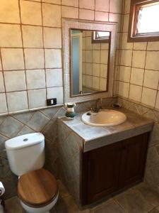 a bathroom with a toilet and a sink and a mirror at El Pajero de Erese in Erese