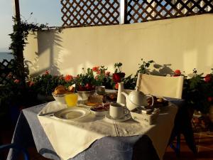 uma mesa com comida para o pequeno almoço com flores em Hotel Dimitra em Tsoukalaíika