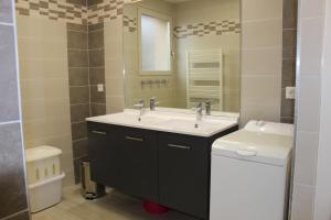 a bathroom with a sink and a toilet and a mirror at Gite En Campagne Isatis in Landemont +10 photos