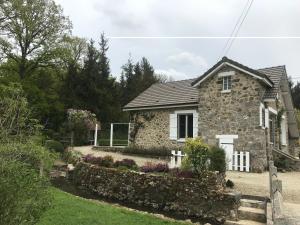 a stone house with a garden in front of it at Gite de L'Hirondelle in Mareuil-en-Brie