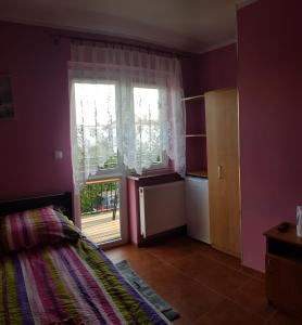 Łóżko lub łóżka w pokoju w obiekcie Pokoje Gościnne Pryzmat