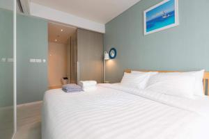 Ένα ή περισσότερα κρεβάτια σε δωμάτιο στο Veranda Residence Pattaya by Boom +40 φωτογραφίες