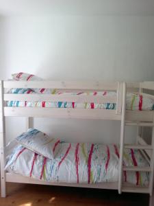 two bunk beds in a room with a pillow at Chez Clémentine in Montolieu