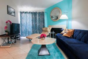 a living room with a blue couch and a table at Strip View luxury Condo in Las Vegas