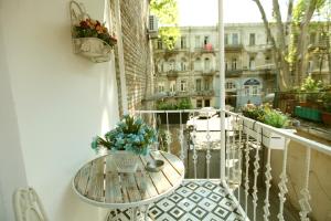 a balcony with a table and a view of a city at Diplomat Apartment in Tbilisi City