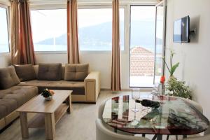 a living room with a couch and a table at JK apartmani in Herceg-Novi