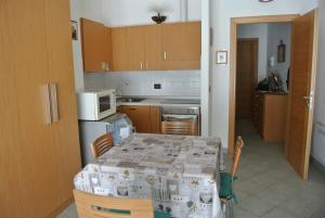 a small kitchen with a table and a microwave at President Palace - Breuil Cervinia - 6 in Breuil-Cervinia
