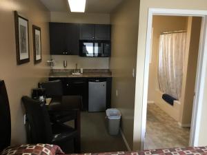 a small kitchen with a sink and a table at Monte Carlo Motel in Barrière +50 photos