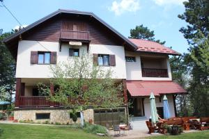 a large house with a red roof at Guest House 3M in Kaludjerske Bare