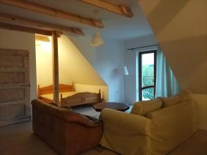 a living room with a couch and a bed at Gosciniec Wydminy in Wydminy