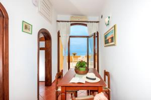 a dining room with a table and a view of the ocean at Casa Chiesa Nuova in Positano